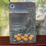 The Hermit turning their back on the bowls of water and back into solitude.