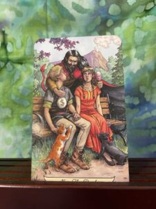 Two lovers sat on a bench, the devil behind them.