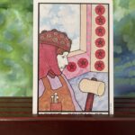 A picture of a man holding a hammer to represent the tarot card the Eight of Pentacles