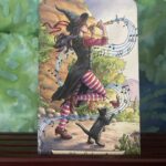 The Tarot Card Judgement, depicted by a witch playing a pipe as she walks away.